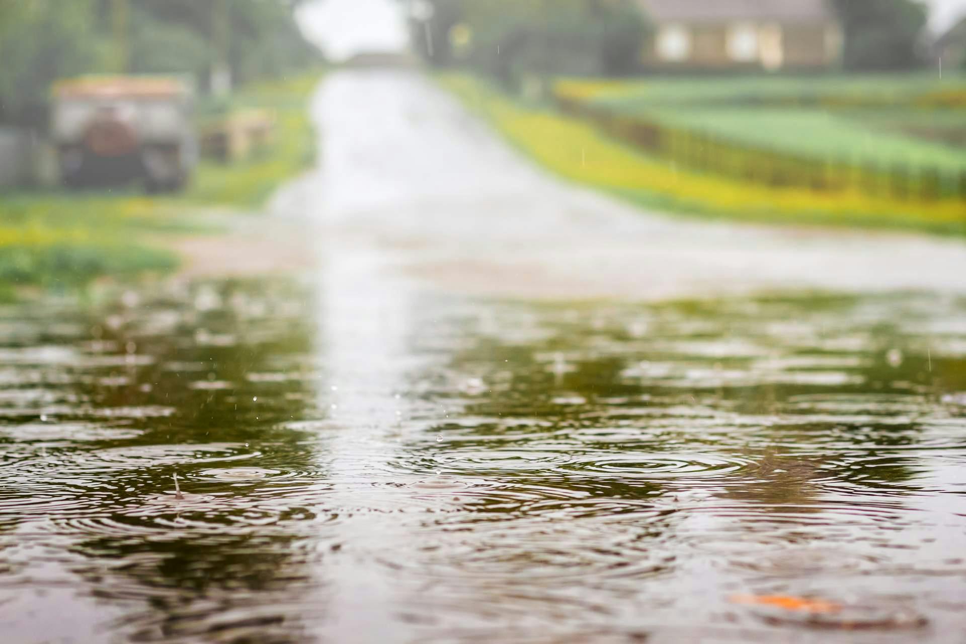 puddle-with-water-road-during-shower-strong-rain-summer-day