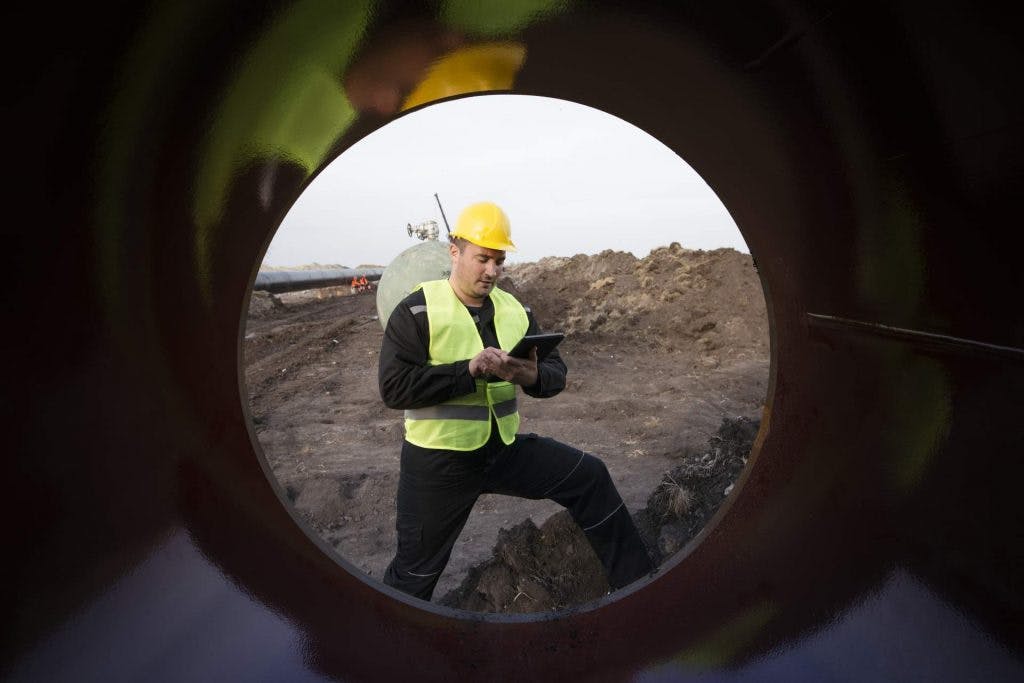 shot-oilfield-worker-checking-quality-gas-pipes-construction-site
