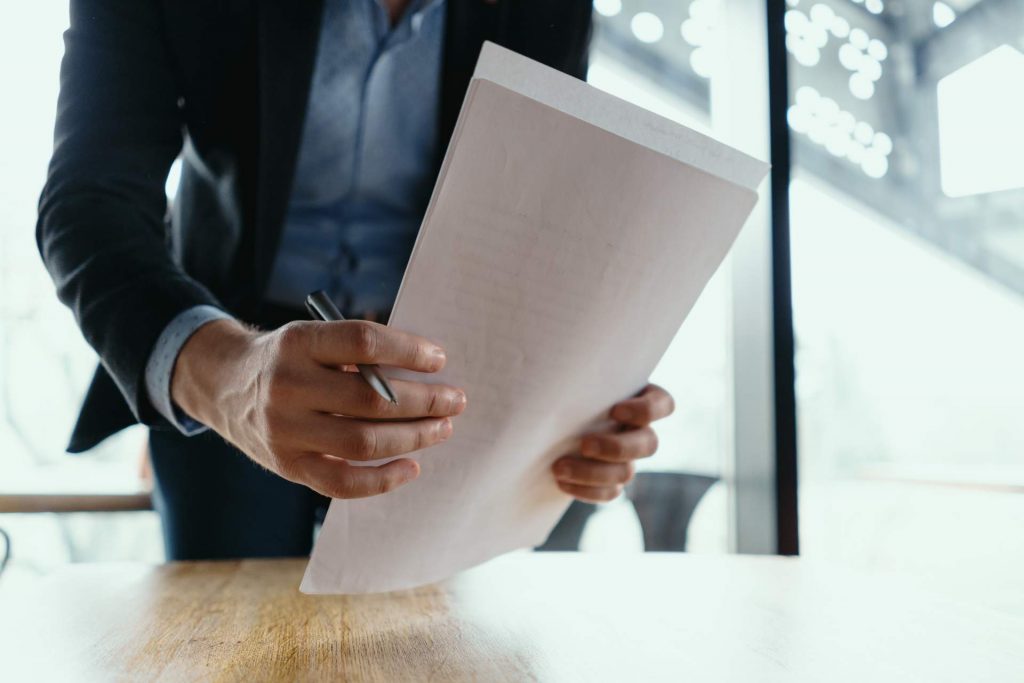 successful-business-man-signing-documents-modern-office